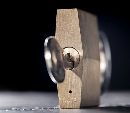 Metal chain and padlock on black backgroundの写真素材