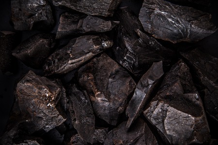 Coal lumps on dark background, close-upの写真素材