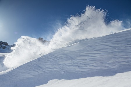 Snow explosion on mountains, freeze motion.