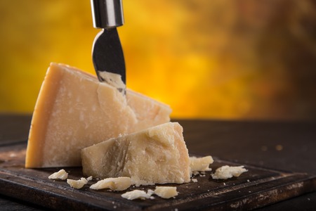 Parmigiano reggiano on wooden background, close-up.の写真素材