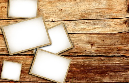 Vintage blank photo frames on wooden backgroundの写真素材