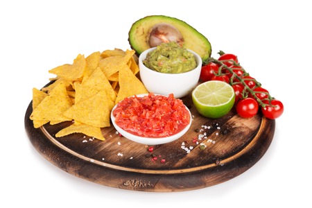 Green Guacamole with nachos and avocado on white backgroundの写真素材