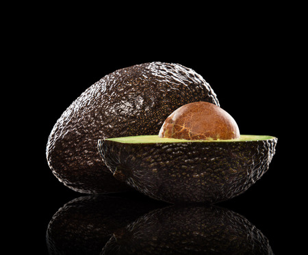 fresh \"ready to eat\" avocado on black backgroundの写真素材