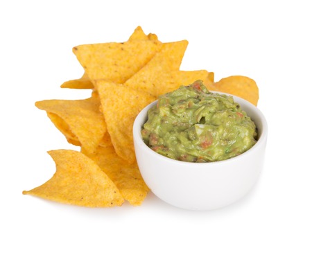Green Guacamole with nachos and avocado on white backgroundの写真素材
