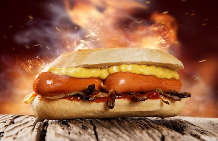 Hot dog with mustard and ketchupon wooden table.の写真素材