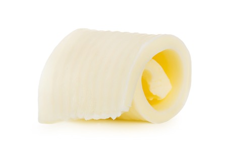 Curls of fresh butter on white backgroundの写真素材