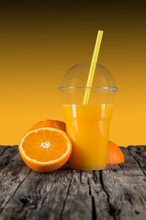 Fresh orange juice on wooden table.の写真素材