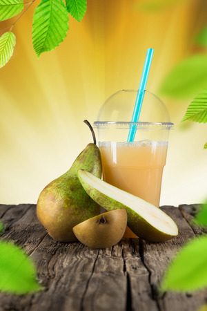 Fresh healthy pear juice, healthy drink on wooden table.の写真素材