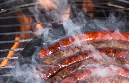 Grilled sausages on the grill, close-up.の写真素材