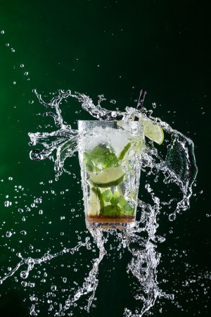 fresh mojito drink with liquid splash, freeze motion.の写真素材