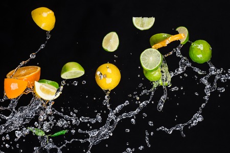 Fresh fruit with water splash on black backgroundの写真素材