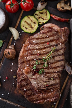 Delicious beef steak on wooden table, close-upの写真素材