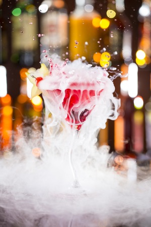 Cocktail with ice vapor on bar desk, close-up.の写真素材
