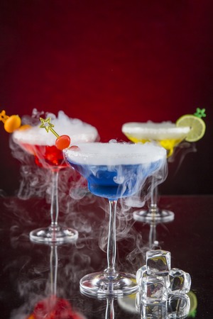 Cocktail with ice vapor on bar desk, close-up.の写真素材