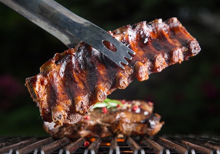 Delicious pork spareribs on grill grate