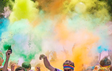 Close-up of marathon, people covered with colored powder.