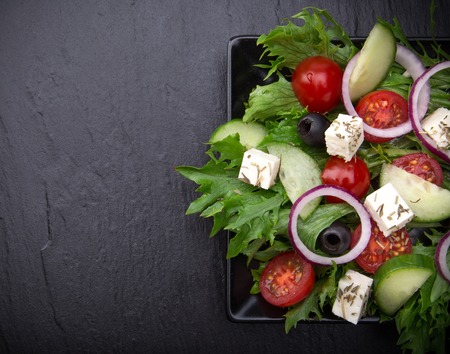Fresh tasty salad on stone backgroundの写真素材