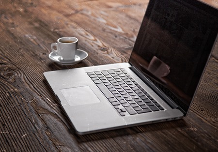young man working from home using smart phone and notebook computer
