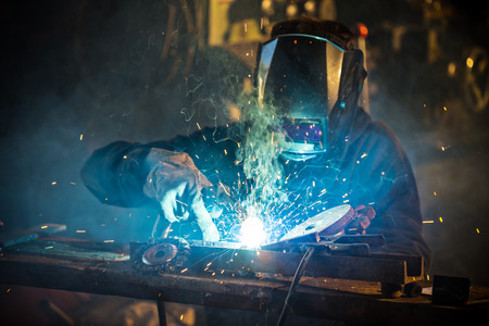 Welder in action with bright sparks