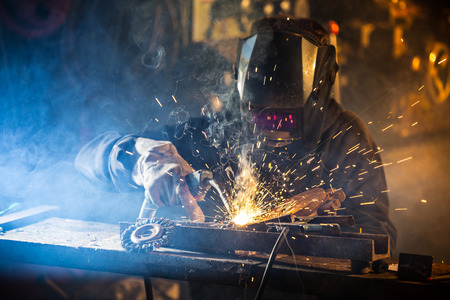 Welder in action with bright sparks