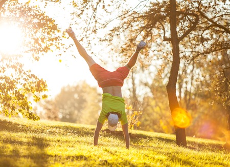 Female training outside during autumn day and listening to music.の写真素材