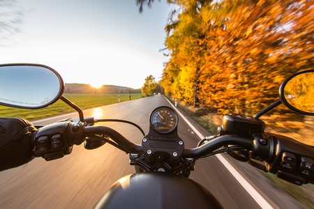 The view over the handlebars of a speeding motorcycle