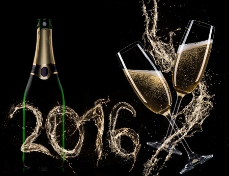 Glasses of champagne with splash, isolated on blackの写真素材