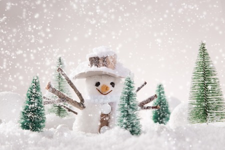 Christmas background with snowman and falling snow.の写真素材
