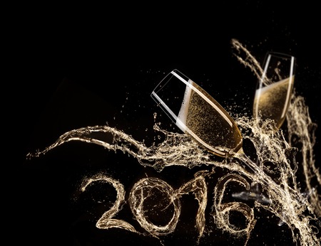 Glasses of champagne with splash, isolated on blackの写真素材