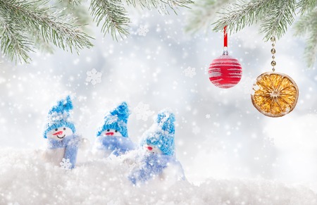 Christmas background with snowmen and falling snow.の写真素材