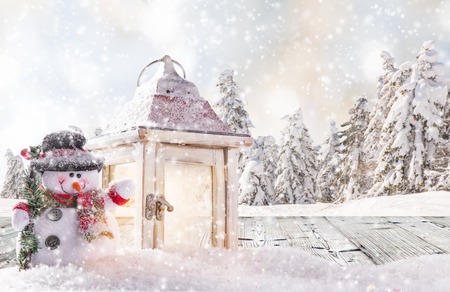 Christmas background with snowman and falling snow.の写真素材