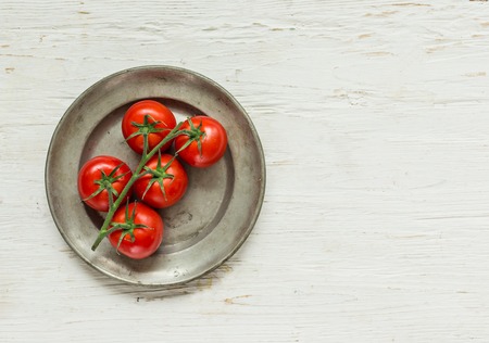 Bowl of tomato sauce with fresh ingredients on white wooden backgroundの写真素材