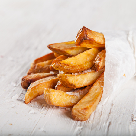 Close-up home made French Fries on White wooden tableの写真素材