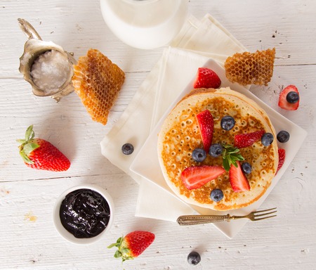 Stack of pancakes with fresh berries, close-up.の写真素材