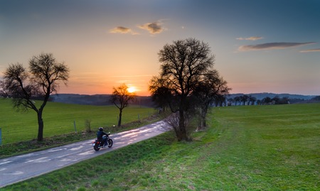 Aerial view of rider on motorcycle during sunset in Czech republic.の写真素材