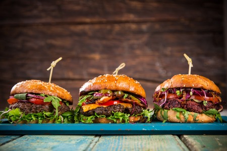 Close-up of home made tasty burgers on wooden table.の写真素材