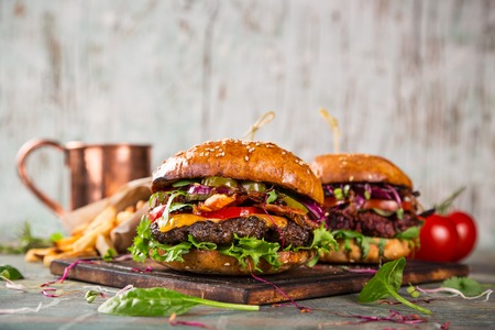 Close-up of home made tasty burgers on wooden table.の写真素材