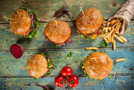 Close-up of home made tasty burgers on wooden table.の写真素材