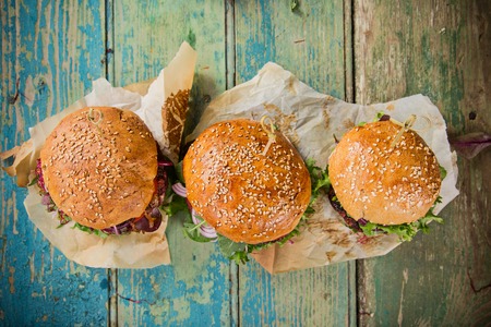 Close-up of home made tasty burgers on wooden table.の写真素材