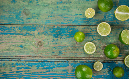 Fresh limes on wooden background, close-up.の写真素材