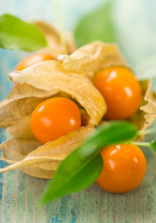 Close-up of Physalis fruits on wooden background.の写真素材