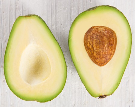 avocados on wooden table, close-up.