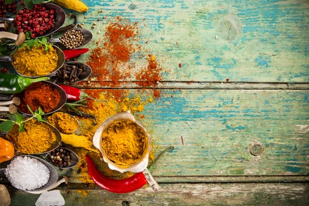 Various colorful spices on wooden table, top view.の写真素材