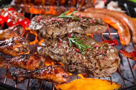 Assorted delicious grilled meat with vegetable on a barbecue grill.の写真素材
