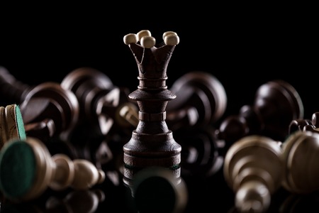 Chess pieces on dark background, close-up.