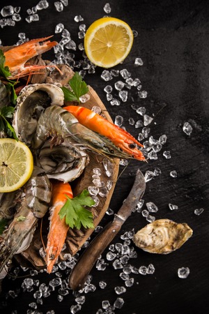 Fresh seafood on black stone, close-up.の写真素材