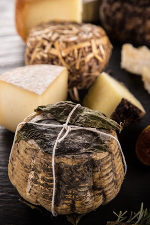 Delicious various cheese on black stone tableの写真素材