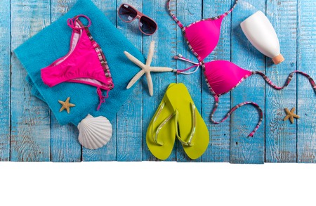 Summer fashion item on old blue wooden table.の写真素材