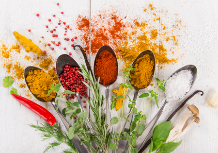 Various colorful spices on wooden table, top view.の写真素材