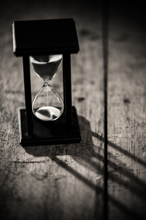 Close-up Hourglass on old wooden background.の写真素材